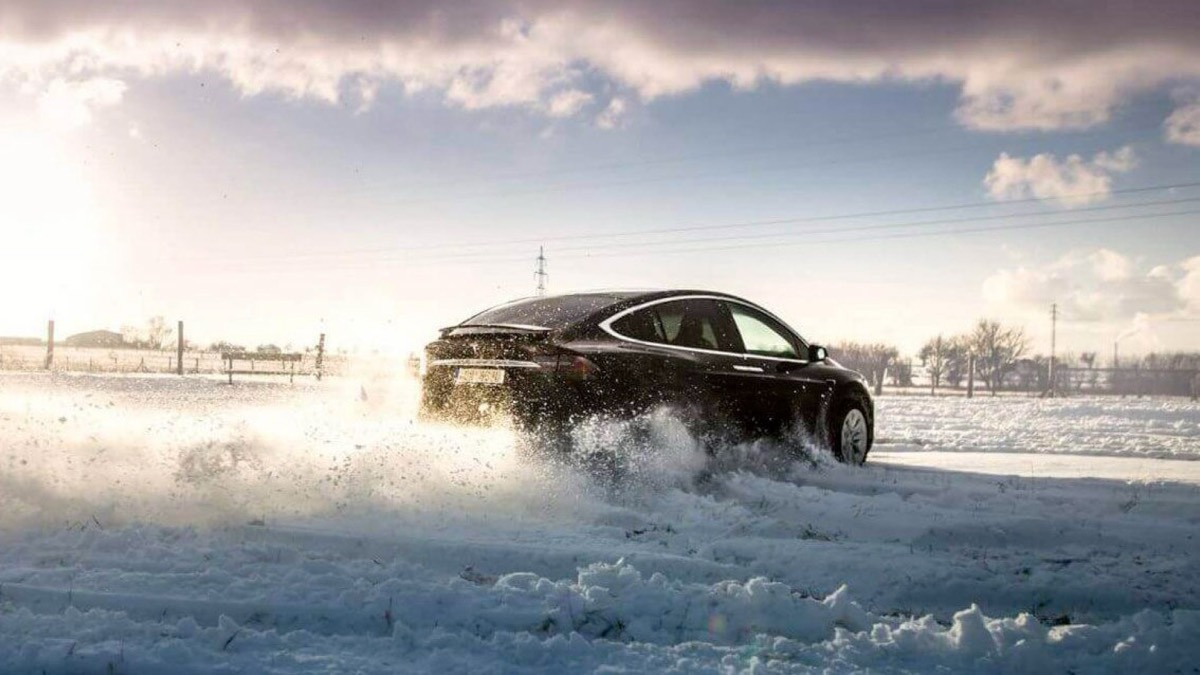 Black Tesla in a snowy landscape