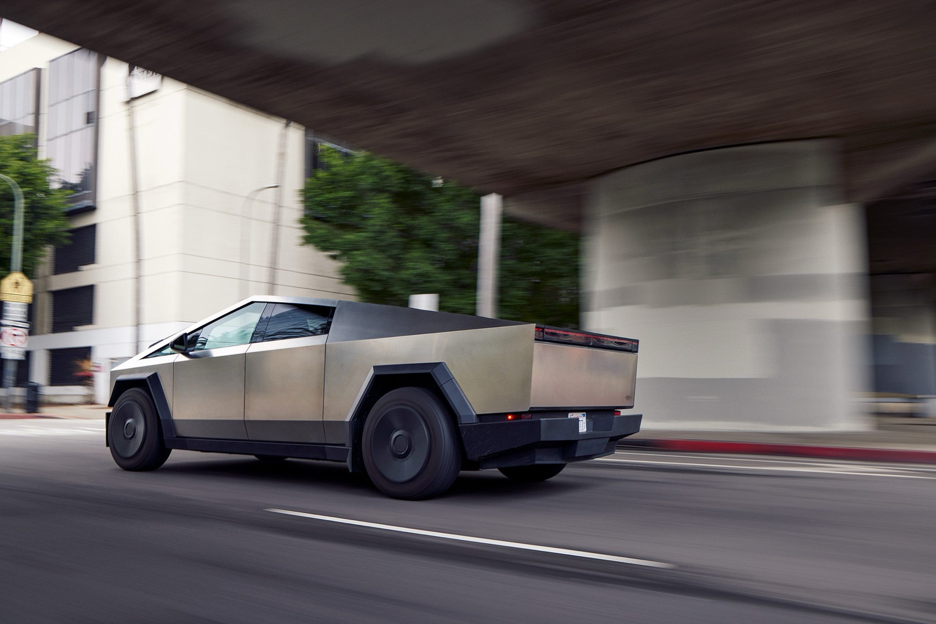 Tesla Cybertruck driving under a bridge